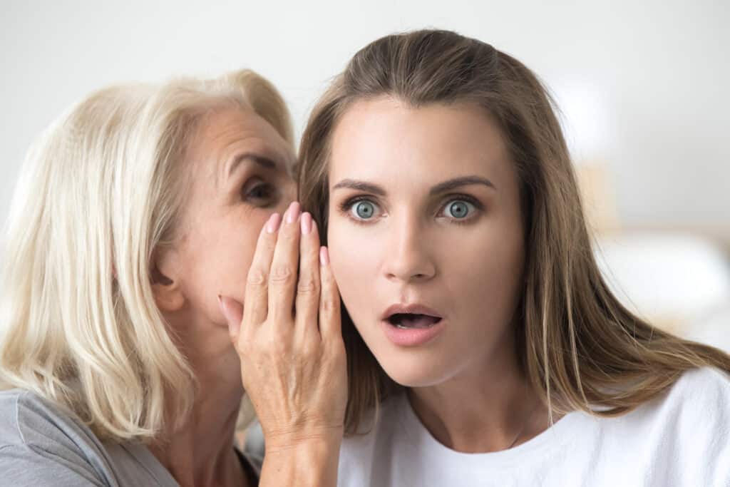 Woman whispering a secret