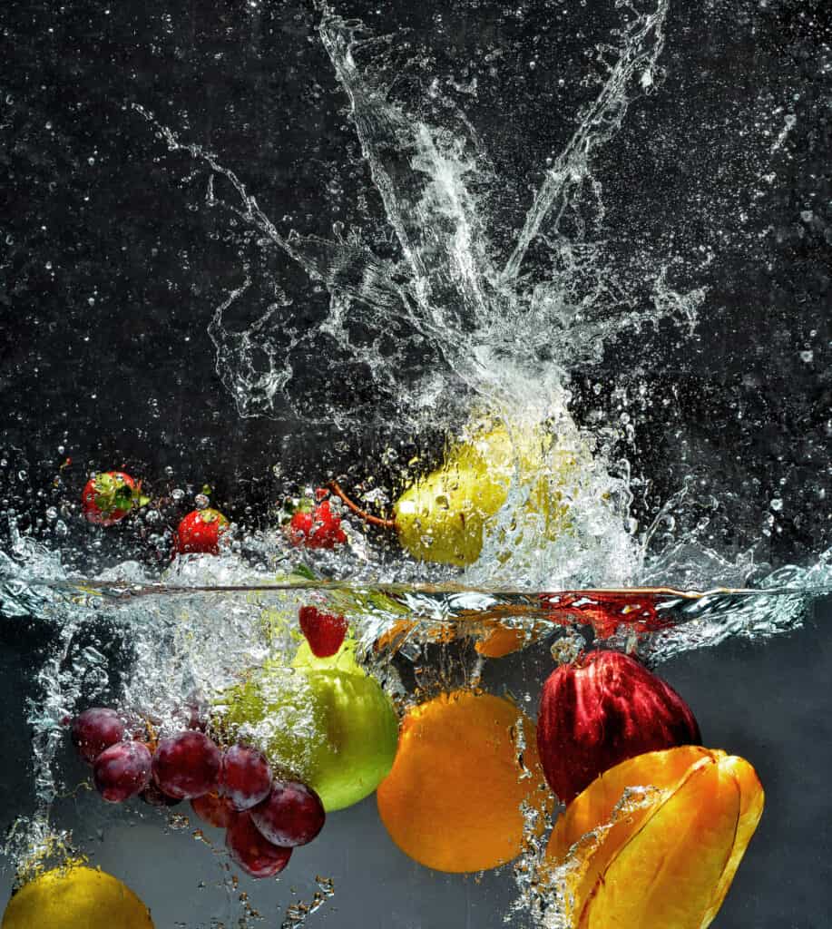 fruits and vegetables making a splash in water while being washed